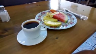 Orta Amerika Alajuela Kosta Rika 'da seçilmiş meyveli papaya muzlu karpuz, ananas ve bir fincan kahve..