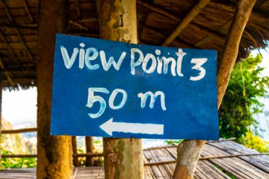 Welcome board and information sign to hiking path way and viewpoint in the tropical jungle and forest to the mountain peak in Vang Vieng Vientiane Province Laos in Southeastasia Asia. clipart