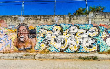 Graffiti and paintings art outside on the street in Zicatela Puerto Escondido Oaxaca Mexico. clipart