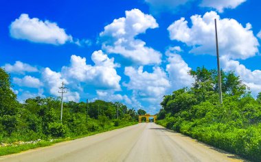 The welcome gate and entrance to the village Kantunilkin Lazaro Cardenas in Quintana Roo Mexico. clipart