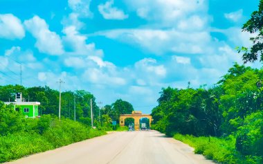 The welcome gate and entrance to the village Kantunilkin Lazaro Cardenas in Quintana Roo Mexico. clipart