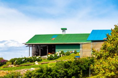 Typical farmhouse with garden in a mountain village in Para Heredia Costa Rica in Central America. clipart