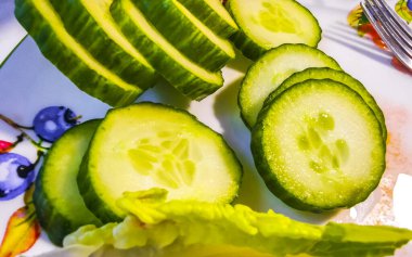 Plate with cucumber sliced and lettuce in Leherheide Bremerhaven Bremen Germany. clipart