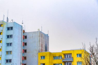 Yellow grey high rise building in winter landscape and cloudy sky in Leherheide Bremerhaven Bremen Germany. clipart