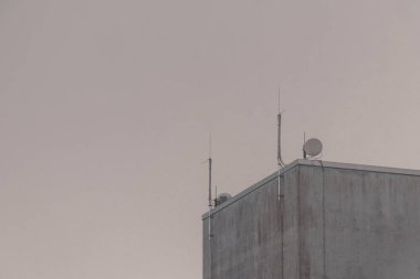 Ugly building with 5G antennas and blue sky in Leherheide Bremerhaven Bremen Germany. clipart