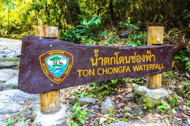 Khao Lak Phang Nga Thailand 08. February 2020 Ton Chongfa Waterfall entrance welcome and information sign signs board boards in Khao Lak Amphoe Takua Pa Phang Nga Thailand. clipart