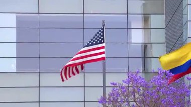 Amerika Birleşik Devletleri bayrağı ve Kolombiya bayrakları Centro Historico City Mexico 'da camdan yapılmış gökdelenin önünde.