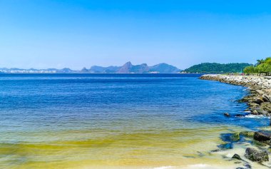 Güzel manzara Panorama Sahili Su Dalgaları Kayalar Dağlar ve Flamengo Plajı 'ndan Niteroi Tepeleri Rio de Janeiro Brezilya.