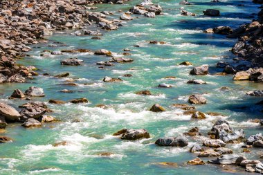 Turkuaz mavi ve yeşil nehir buharı ve köprü taşlı şelale hanı. Çimen ağaçları, doğa ve dağ manzarası. Alplerde uçan Landeck Tyrol Avusturya..