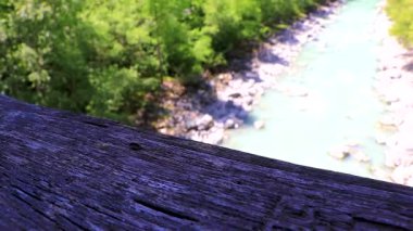 Turquoise blue and green river steam and waterfall Inn with stones rocks grass trees nature and mountain panorama in the Alps Flie Landeck Tyrol Austria.
