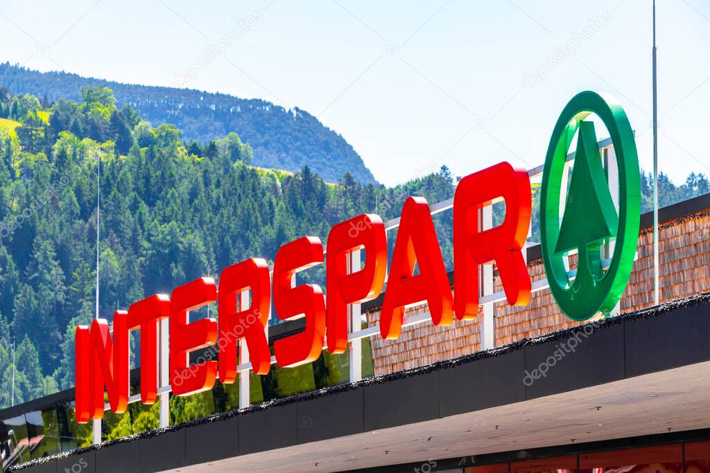 Imst Tyrol Austria 31. May 2025 Interspar supermarket brand logo red and green welcome sign at the entrance in the Alps Imst Tyrol Austria.