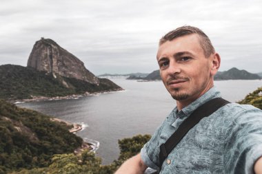 Yakışıklı Gezgin Şeker Somun Dağı Tepesi 'nde poz veriyor Rio de Janeiro Brezilya' nın Urca Köyü 'nde Pao de Acucar Panorama Manzarası.