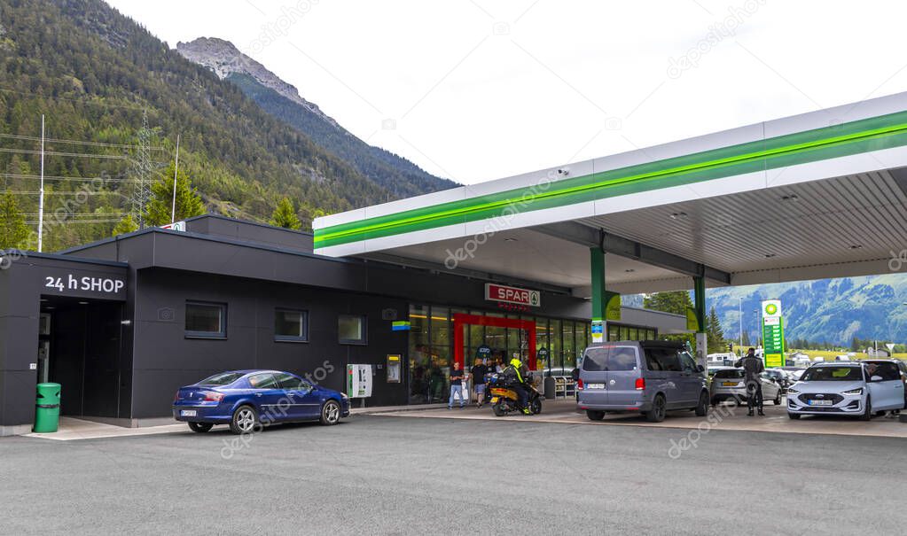 Reutte Tyrol Austria 01. June 2025 BP gas station brand and parking lot with mountains in the Alps Reutte Tyrol Austria.