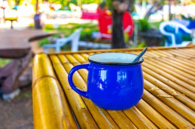 Thalang District Phuket Province Thailand 12. February 2020 Stylish coffee cup mug on wooden bamboo table in tropical paradise in Mai Khao Thalang on Phuket island Thailand in Southeastasia Asia.