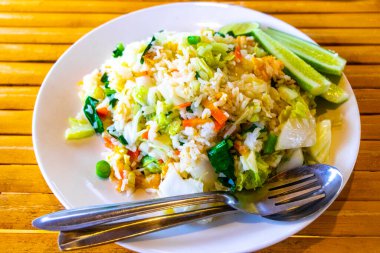 Asian deep stir fried vegetable rice with cucumber and egg in Mai Khao Thalang District on Phuket island Province Southern Thailand in Southeastasia Asia.