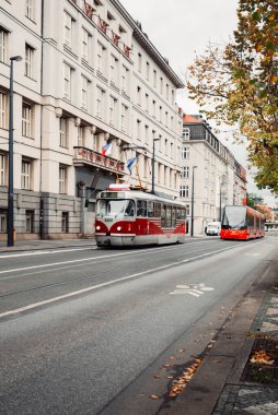 PRAG, CZECHIA - 31 Ekim 2023 Prag şehir merkezindeki eski kırmızı tramvayın dikey fotoğrafı. Prag 'da trafik - şehir konseptinde ulaşım. Prag 'daki modern ve eski tramvaylar.