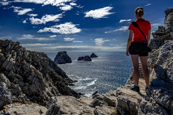 stock image Young Woman Stand At The Edge Of The Cliffs At Pointe De Penhir At The Finistere Atlantic Coast in Brittany, France