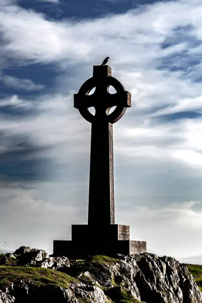 Celtic Cross With Bird Of Prey Kestrel On Island Ynys Llanddwyn On The Isle Of Anglesey In North Wales, United Kingdom