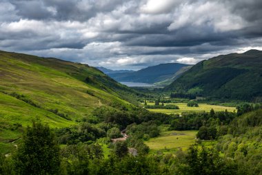 Corrieshalloch Gorge National Nature Reserve With River Through Pasture Valley And Loch Broom In Scotland, UK clipart