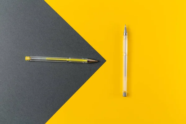 stock image Yellow and gray gel pens on a yellow and gray background.