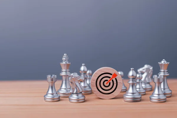 Target and goal expansion concept, Chess figures around dartboard and arrow for creative and set up business objective target goal, marketing solution, target for business investment.
