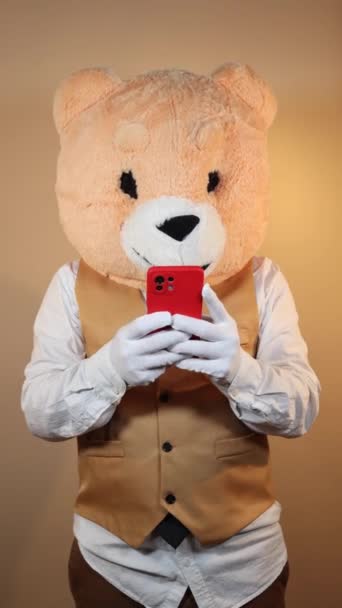 Man Bear Mask Using Mobile Phone Yellow Color Background Vertical — Video Stock
