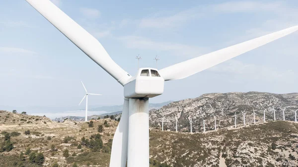 Wind turbine farm power generator in natural landscape for renewable green energy production is environment friendly industry. Sustainable development technology concept.