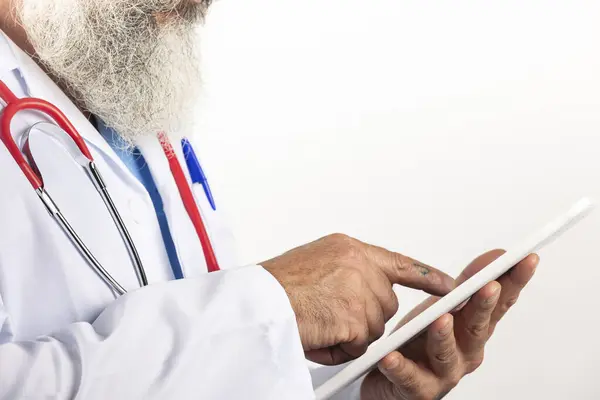 Close up of a male doctor holding a tablet on a white background