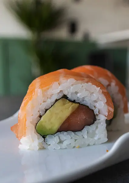 Sushi rolls Japanese food. California sushi roll with tuna, avocado and salmon close up. Japanese restaurant menu.