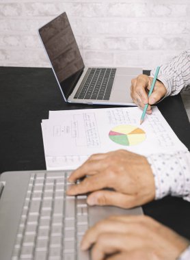 Ofiste bir pazarlama stratejisini analiz eden iki işçi var. Kapat.