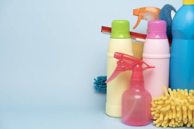 House cleaning plastic product on blue table background, home service or housekeeping concept