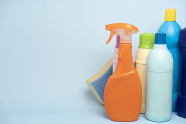 House cleaning plastic product on blue table background, home service or housekeeping concept