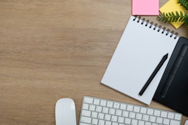 close up of workspace desk with clock, notebook, computer keyboard wooden table background with copy space, minimal style, for creative flat lay concept