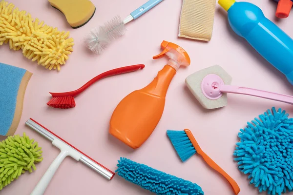 House cleaning plastic product on pink table background, home service or housekeeping concept