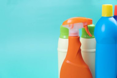 House cleaning plastic product on green table background, home service or housekeeping concept