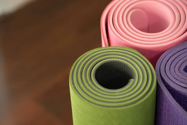 close up of colorful yoga mat on the table, sport and healthy concept