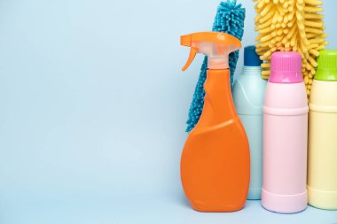 House cleaning plastic product on blue table background, home service or housekeeping concept