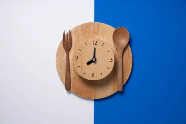 Food clock spoon and fork, Healthy food breakfast concept on the table background