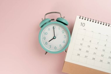 Pembe masa arkaplanındaki takvim ve alarmın kapatılması, iş toplantısı ya da seyahat planlama konsepti