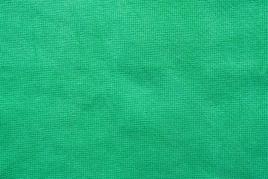 Kumaş kumaş yeşil doku arka planı, kumaş tekstil yüzeyinin soyut görüntüsü.