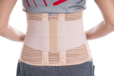 young woman wearing back support for protect her back, medicine and healthy concept.