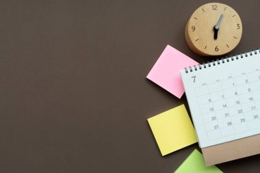 Takvimi saat başına kapat kahverengi masa arkaplanı, iş toplantısı veya seyahat planlama konsepti