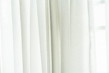 close up of white curtain in the room at home with sunlight