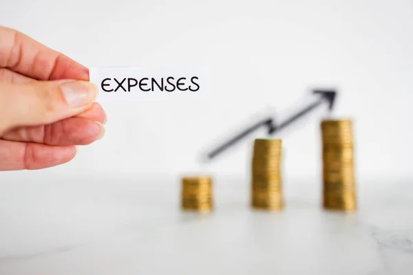 Hand Holding Expenses Text Front Growing Stacks Coins Arrow Going — Stock Photo, Image