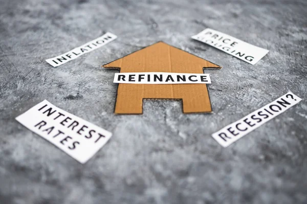 house with refinance text surrounded by concepts like interest rates inflation recession and price gouging, worldwide economic issues after the pandemic