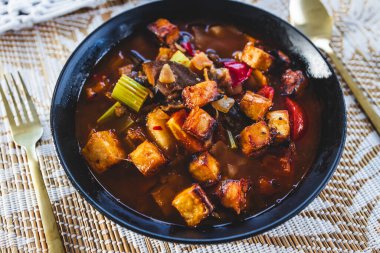 Tofu ve patlıcanla birlikte bitki bazlı sıcak tencere baharatlı sebze çorbası, sağlıklı vegan yemek tarifleri.