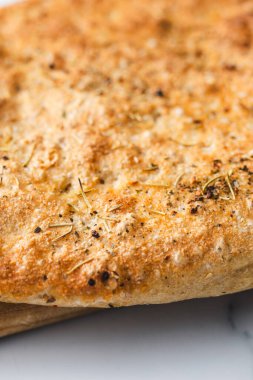 Biberiye ve tuz taneli ev yapımı Focaccia ekmeği, sağlıklı vegan yemek tarifleri.