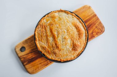 homemade round puff pastry pie in style of a sheperd's pie with sesame seeds topping just out of the oven, healthy food recipes