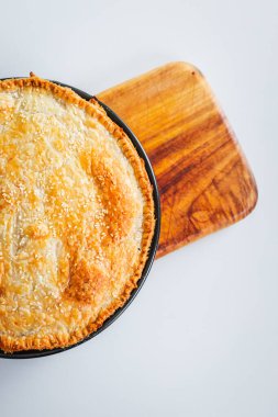 homemade round puff pastry pie in style of a sheperd's pie with sesame seeds topping just out of the oven, healthy food recipes