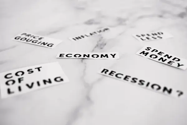 stock image Inflation and recession conceptual image, economic terms scatered on marble desk